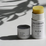 Recover Lip Balm with lid off. 100% Natural and Vegan lip balm in a compostable tub.